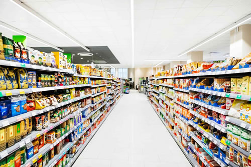 A blurry abstract image of a supermarket aisle.
